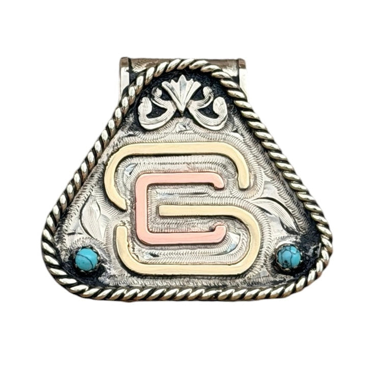 A silver-toned triangular money clip with a twisted rope border, a central rose gold and gold 'GS' monogram, and two small blue gemstones, shown on a plain white background.